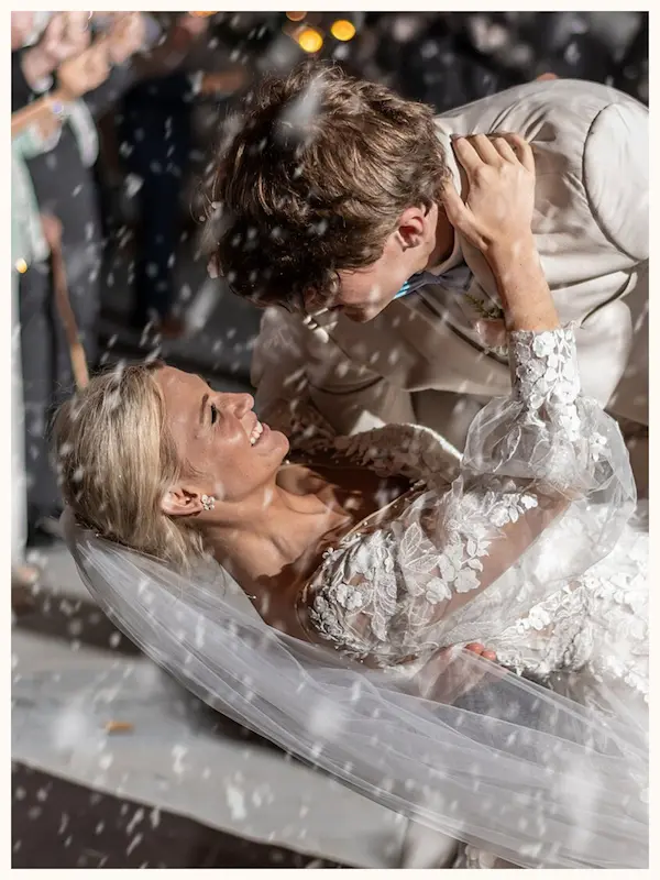 Happy couple on wedding day dipping for first kiss, courtesy of Goodman Photography in Warner Robins
